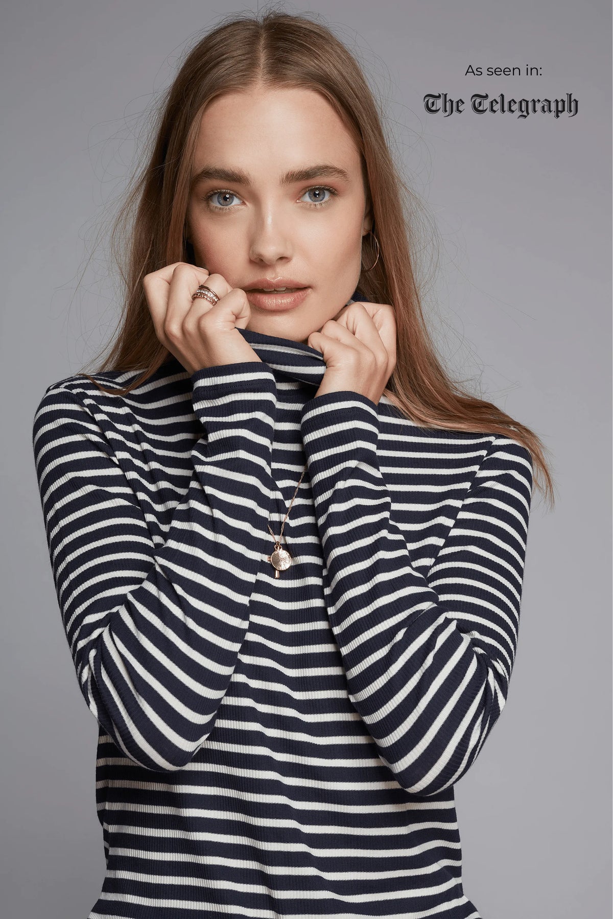 Woman wearing a black and white striped sweater on a gray background with 'The Telegraph' branding.