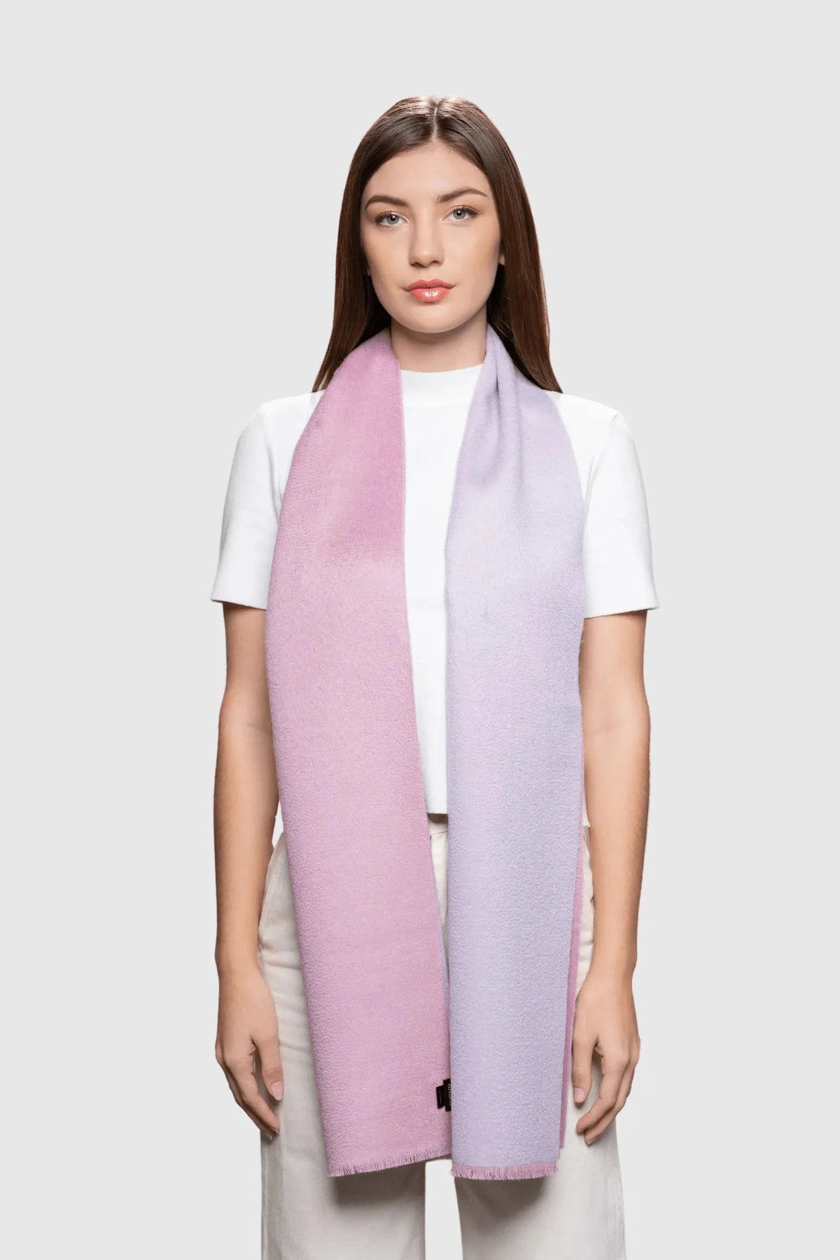 Woman wearing a pastel gradient scarf on a white background